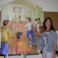 Chris in front of a Mural at a school